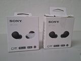 two boxes of sony headphones sitting on top of a table