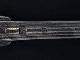 a close up of a silver spoon on a black background
