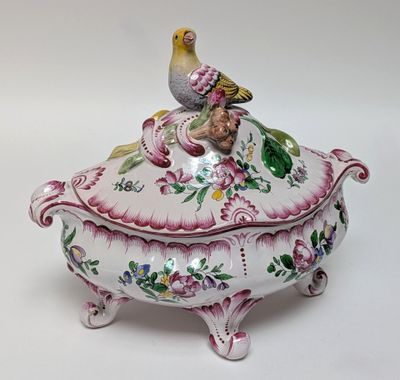 a bird sitting on top of a decorative box