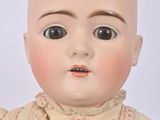 a close up of a doll with a bald head