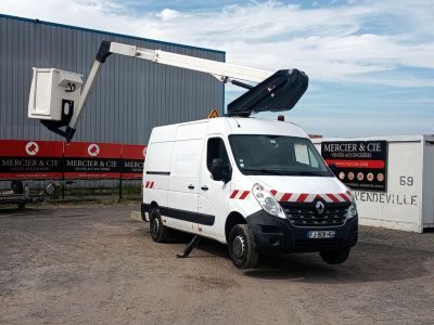 une camionnette blanche garée devant un immeuble sur le toit duquel se trouve une grue