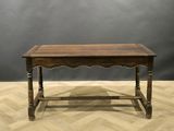 an old wooden table on a parquet floor with a gray background