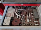 a tool box full of tools that are sitting on the floor