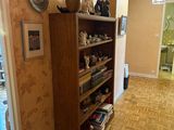a room with a wooden floor and a book shelf in it