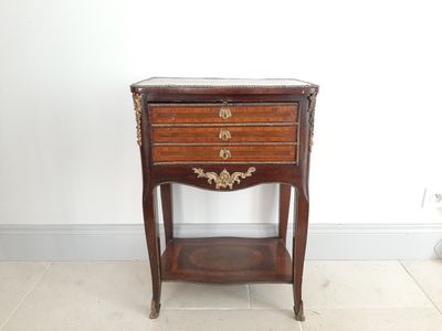 an old wooden table with a drawer on top of it in a room