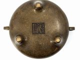 a metal object that has a black and gold logo on it