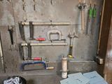 a bunch of tools hanging on a wall in a room