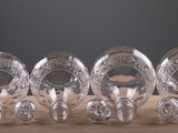 six clear glass vases sitting on top of a wooden table