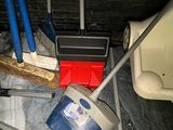 a picture of a toilet with a bucket and a broom in it