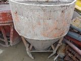 a cement mixer sitting in the middle of a pile of junk