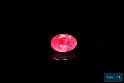 a pink diamond on a black background