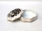 a white box with a leopard print lid on it