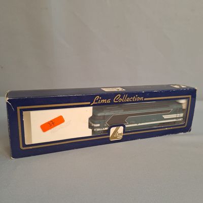 a box with a toy gun in it on a table