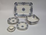 blue and white porcelain dinnerware with a blue star design on it