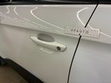 a close up of a car door handle with a sticker on it