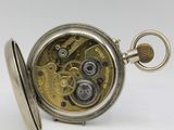 an antique pocket watch with a silver case and a gold dial