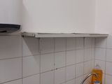 a person that is taking a picture of a kitchen sink