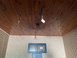 a blue door in a room with a wooden ceiling