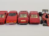 five toy cars lined up in a row next to each other