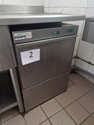 a silver dishwasher sitting in the corner of a kitchen