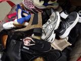 many pairs of shoes that are sitting in a basket