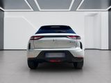 the rear end of a white car in a white room