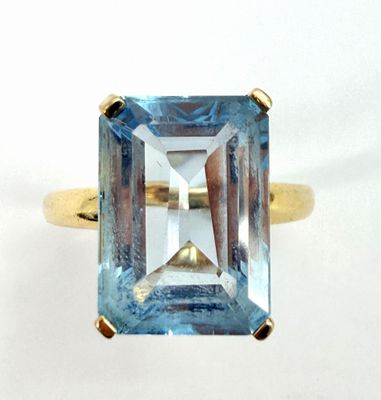 an image of a ring with a blue topaz stone