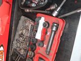 a red tool box filled with various tools in it