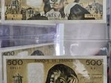 a picture of a couple of bank notes in a display case