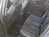 the back seats of a car are black with purple stickers on them