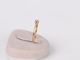 yellow gold ring with a single diamond on top of a white stone