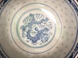 a blue and white bowl with a dragon on it