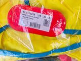 a yellow hat that has a red tag on it