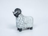 sheep figurine in white and black on a white background