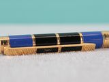 a blue pen sitting on top of a white surface