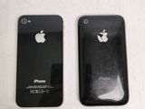 two black iphones sitting side by side on a table