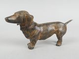 bronze statue of a dachshund dog on a white background