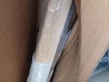 a cardboard box with plastic wrap and a toothbrush inside of it