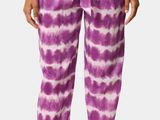 a woman wearing a purple tie dye top and purple pants