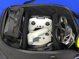 a bag with a video game controller and a helmet in it