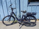 a blue bike parked in front of a blue building