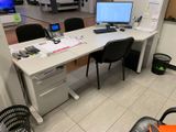 a desk with a computer on it in a room
