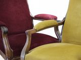 two red and yellow chairs sitting next to each other in a room