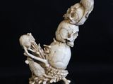 an image of a statue of a bird with a skull on it ' s back