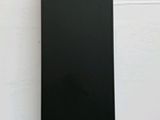 a close up of a black speaker on a white surface