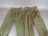 two pairs of khaki pants are lined up on a white surface