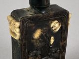 an old black and white box with a picture of a man on a horse
