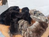 a pile of fur on top of a wooden chair