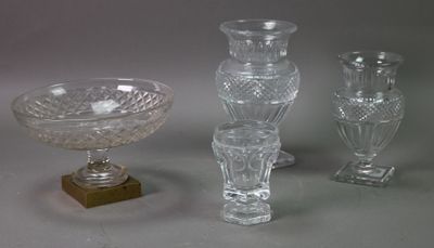 three glass vases and a bowl are sitting on a table
