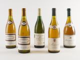 six bottles of wine are lined up in a row on a white surface